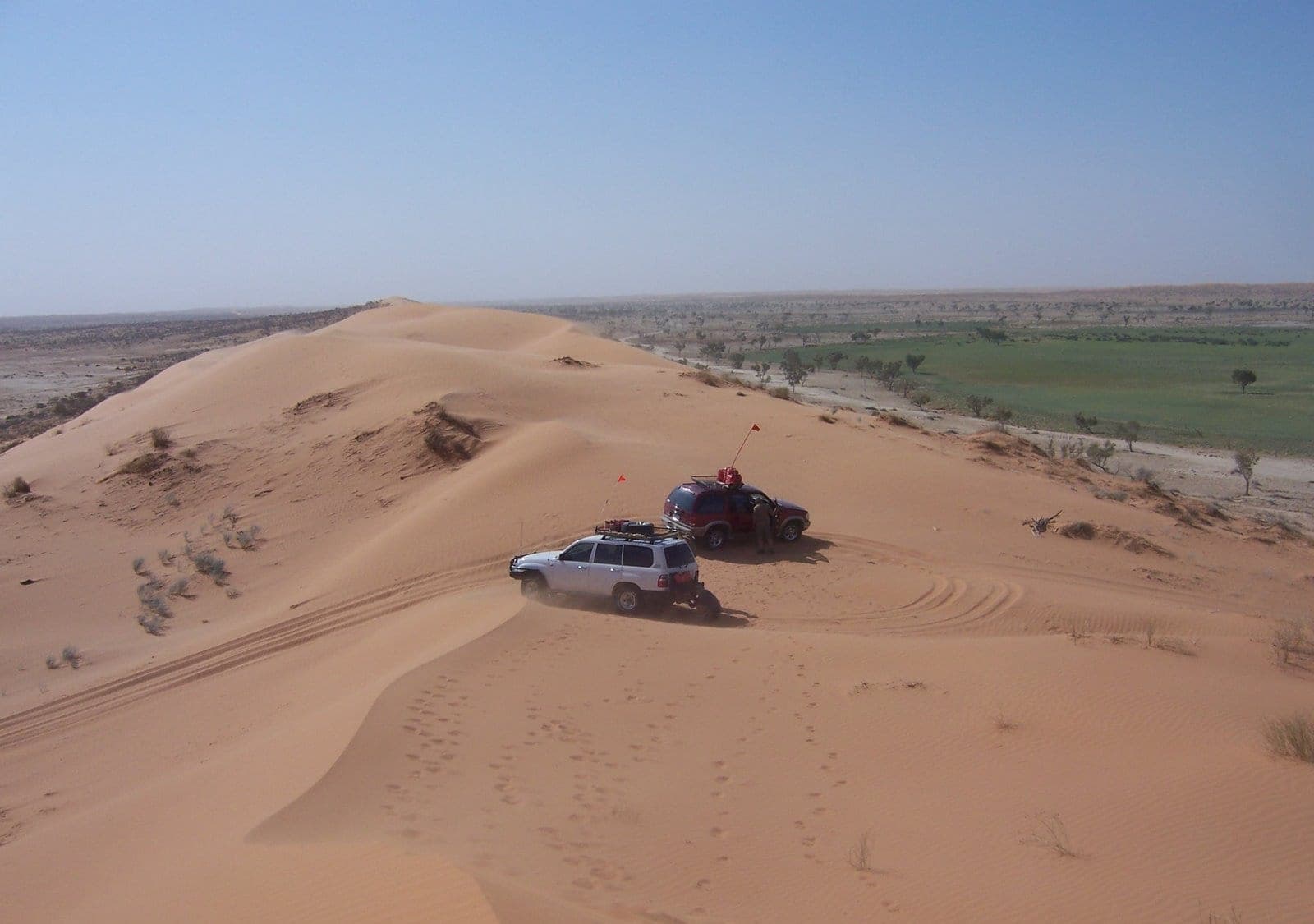 Vehicles on a red sand dune in the Simpson Desert